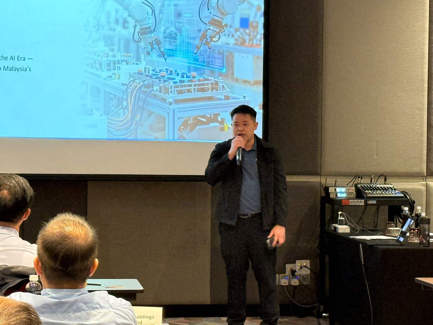 Speaker presenting on AI-era infrastructure during the summit
