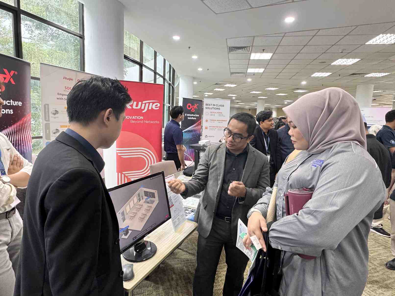 University visitors engaging with Ruijie and OGX booth at MAPITA