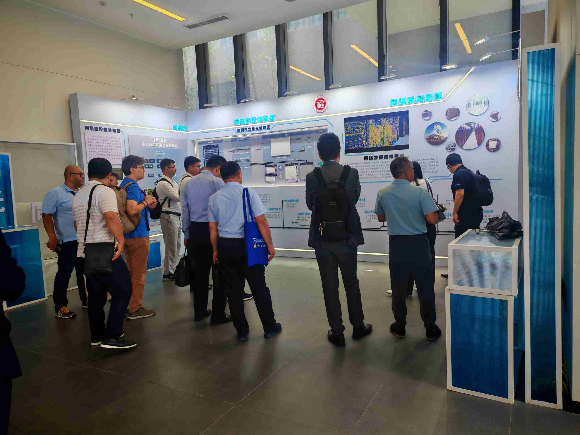 Delegation touring the network development exhibit at Fuzhou University
